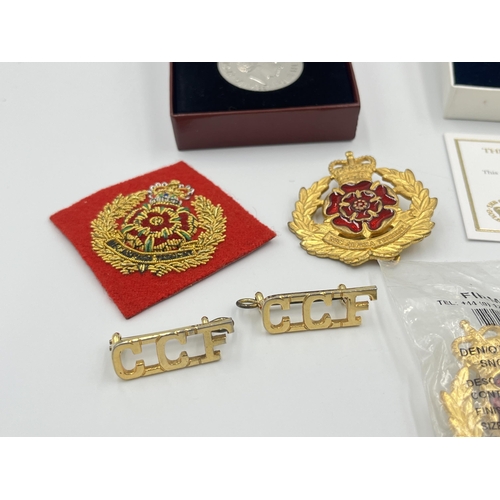 2232C - A collection of medals and badges to include a boxed Royal Mint The Queen's Golden Jubilee medal wit... 