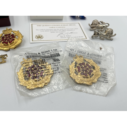 2232C - A collection of medals and badges to include a boxed Royal Mint The Queen's Golden Jubilee medal wit... 