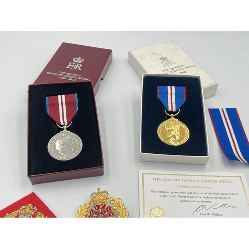 2232C - A collection of medals and badges to include a boxed Royal Mint The Queen's Golden Jubilee medal wit... 