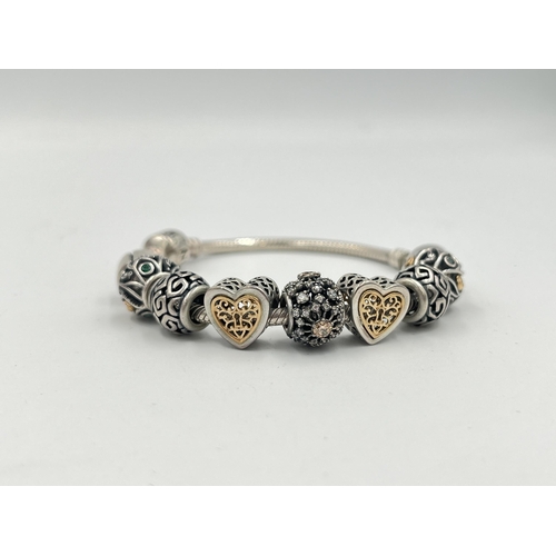 2334 - Seven pieces of Pandora .925 silver jewellery, two charm bracelets, three rings, one bangle and one ... 