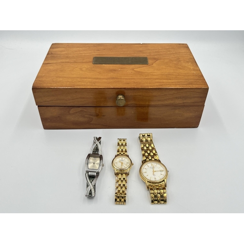 2343 - A 1960s hardwood presentation wristwatch case containing three quartz wristwatches to include two Ro... 