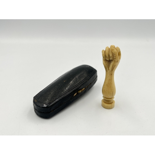 2350 - A boxed Victorian hand carved bone wax seal with hidden photograph of two nude ladies