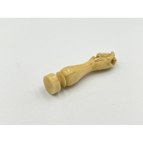 2350 - A boxed Victorian hand carved bone wax seal with hidden photograph of two nude ladies