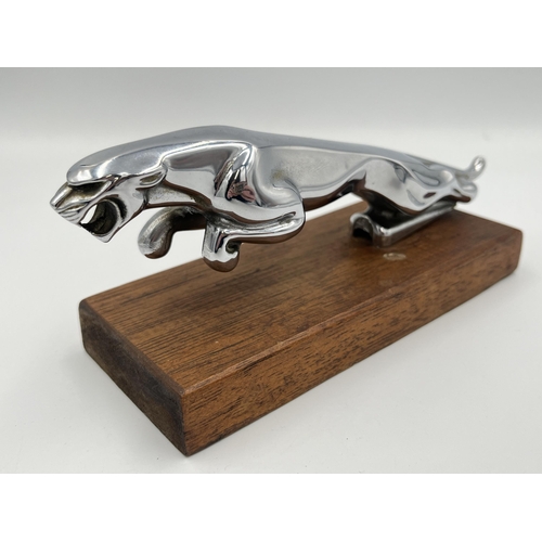 2354 - A vintage Jaguar chrome plated car mascot on oak plinth