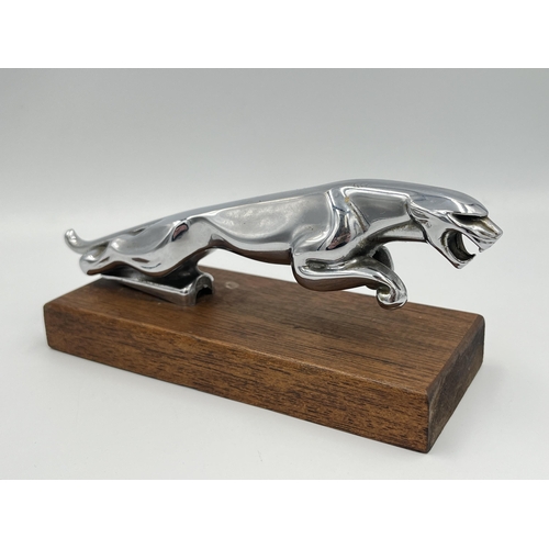 2354 - A vintage Jaguar chrome plated car mascot on oak plinth