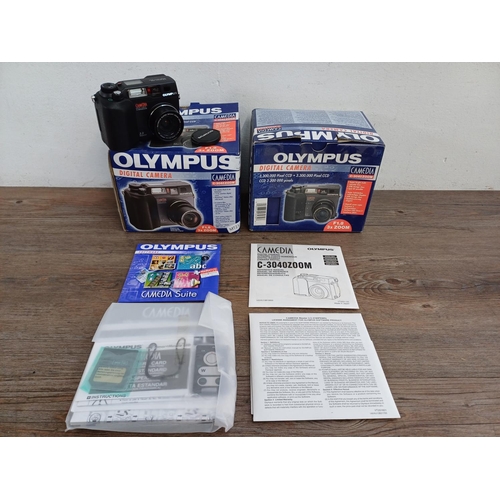 634 - Two boxed and packaged Olympus C-3040ZOOM Camedia 3.3mp digital cameras with software and accessorie... 