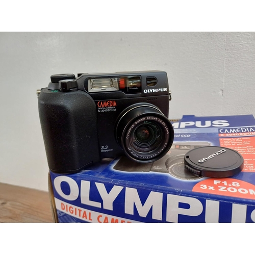 634 - Two boxed and packaged Olympus C-3040ZOOM Camedia 3.3mp digital cameras with software and accessorie... 