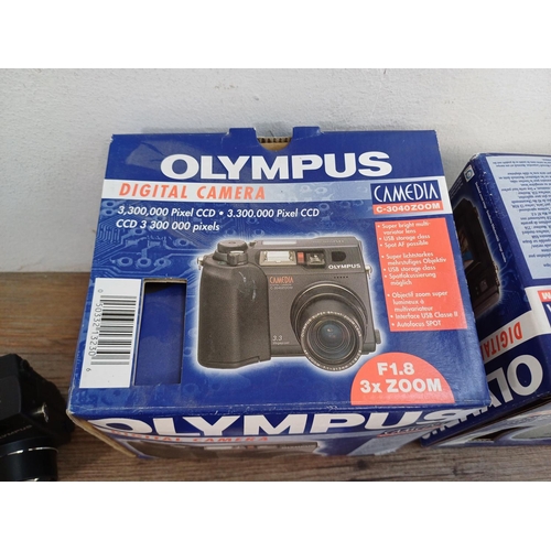 634 - Two boxed and packaged Olympus C-3040ZOOM Camedia 3.3mp digital cameras with software and accessorie... 