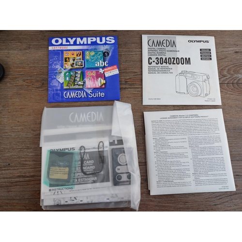 634 - Two boxed and packaged Olympus C-3040ZOOM Camedia 3.3mp digital cameras with software and accessorie... 