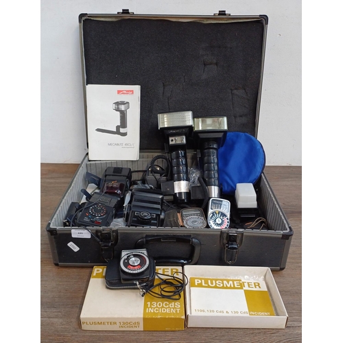 635 - A flight case containing Metz Mecablitz 45CL-1 and 45CT-5 flashes, Weston Master IV and Euro-Master ... 