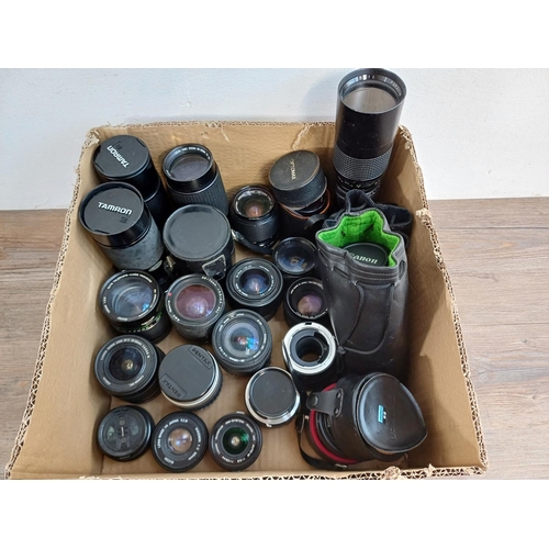 645 - A collection of camera lenses to include Vivitar, Canon, Olympus Zuiko, Sigma, Konica Hexanon etc.