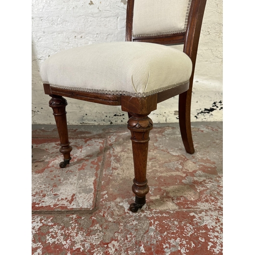 168 - A pair of 19th century carved oak and fabric upholstered occasional chairs on original castors