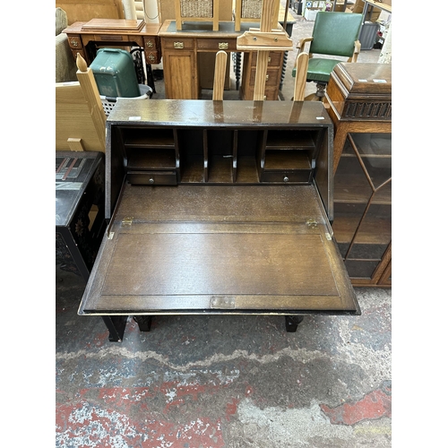 183 - A mid 20th century carved oak bureau - approx. 100cm high x 76cm wide x 40cm deep