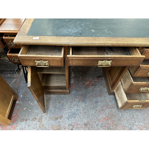 207 - An early 20th century oak pedestal writing desk - approx. 77cm high x 121cm wide x 66cm deep
