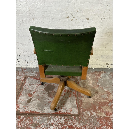 208 - A mid 20th century beech and green vinyl swivel office desk chair