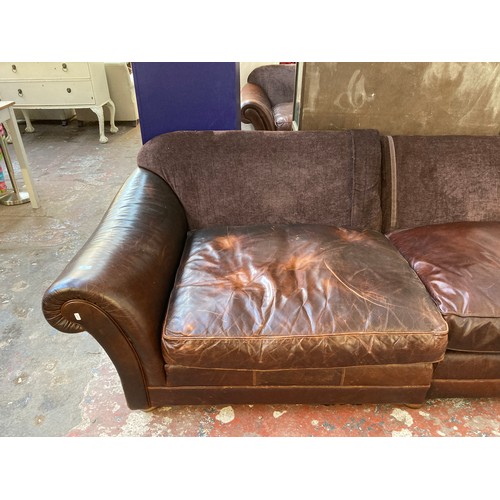 81 - A brown leather and fabric upholstered four seater sofa - approx. 79cm high x 252cm x 106cm
