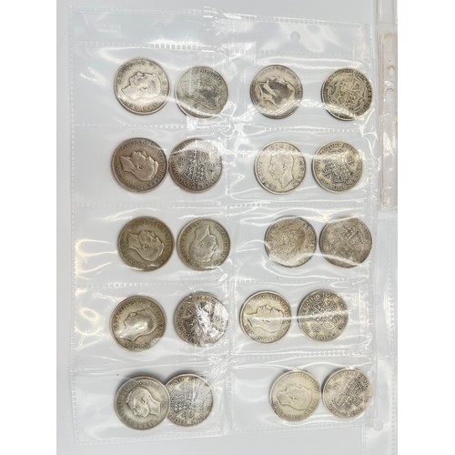 2245C - A collection of coins and medals to include twenty four .500 silver half crowns etc.