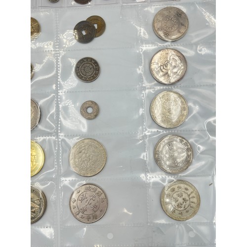 2245E - A collection of coins to include Chinese silver 1 yuan, Japanese silver 50 sen, two .925 silver thre... 