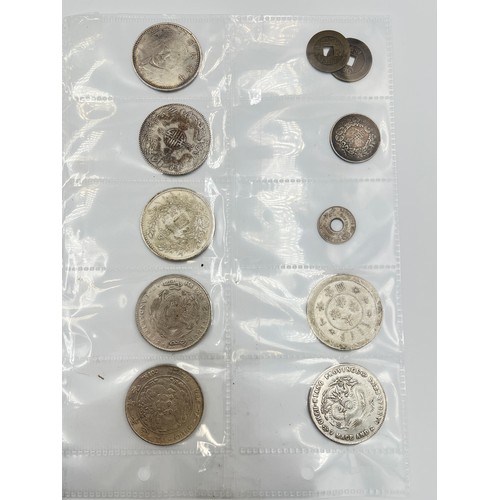 2245E - A collection of coins to include Chinese silver 1 yuan, Japanese silver 50 sen, two .925 silver thre... 