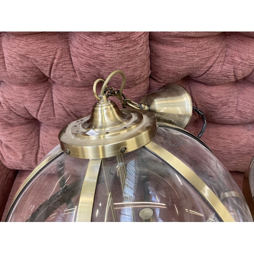 202 - A pair of Laura Ashley Odiham 3691112 brass and glass three branch sphere pendant lights