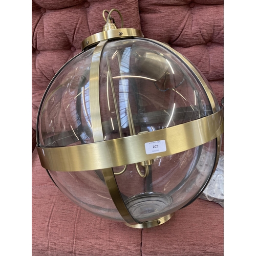 202 - A pair of Laura Ashley Odiham 3691112 brass and glass three branch sphere pendant lights