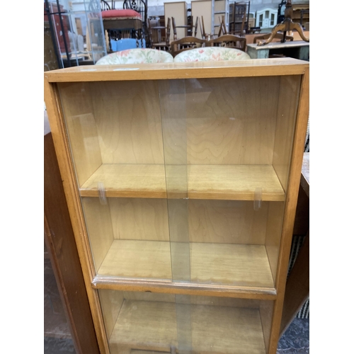 216 - A mid 20th century beech four tier bookcase with four glass sliding doors - approx. 93cm high x 42cm... 