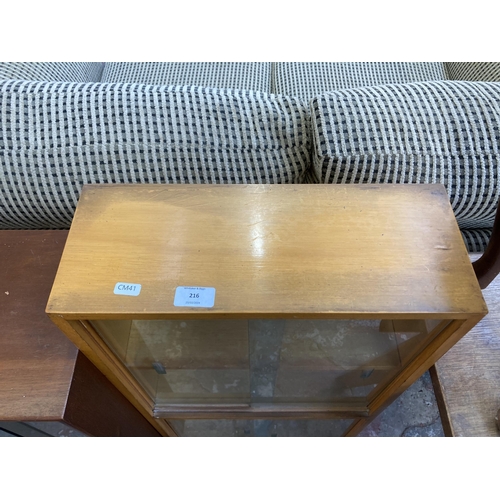 216 - A mid 20th century beech four tier bookcase with four glass sliding doors - approx. 93cm high x 42cm... 