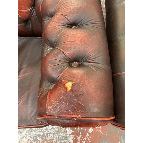 222 - A pair of oxblood leather Chesterfield club chairs