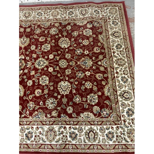 225 - An Aristocrat red rug - approx. 230cm x 160cm