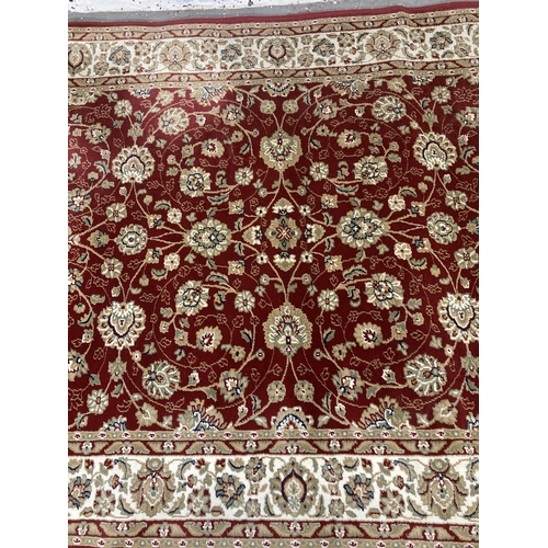 225 - An Aristocrat red rug - approx. 230cm x 160cm