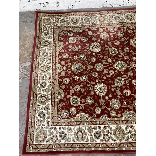 225 - An Aristocrat red rug - approx. 230cm x 160cm