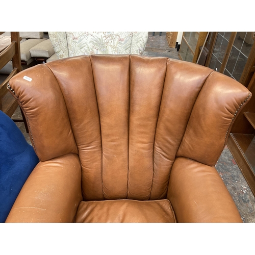 227 - A Georgian style tan leather wingback armchair on ball and claw supports