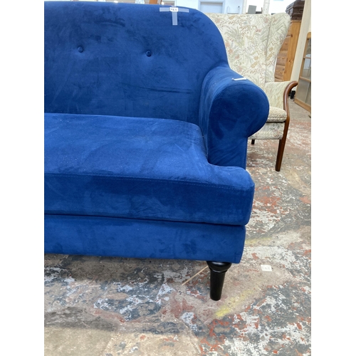 228 - A Victorian style blue fabric upholstered two seater sofa