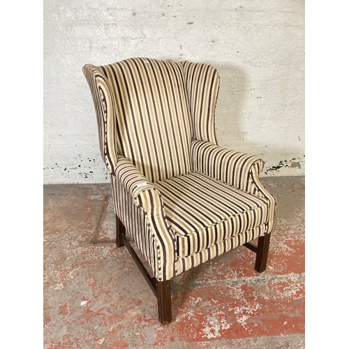 166 - A Georgian style fabric upholstered wingback armchair