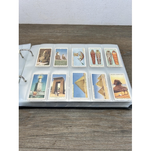 493 - A cigarette card album containing a large collection of various cigarette cards