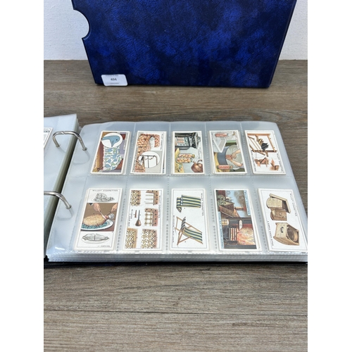 494 - A cigarette card album containing a large collection of various cigarette cards