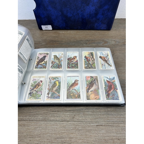 494 - A cigarette card album containing a large collection of various cigarette cards