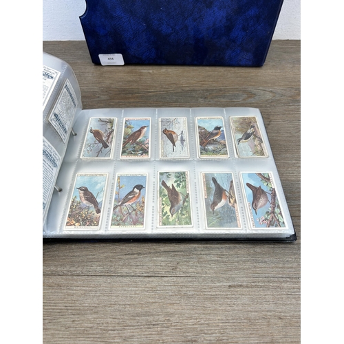 494 - A cigarette card album containing a large collection of various cigarette cards