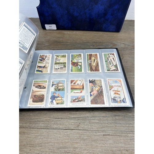 494 - A cigarette card album containing a large collection of various cigarette cards