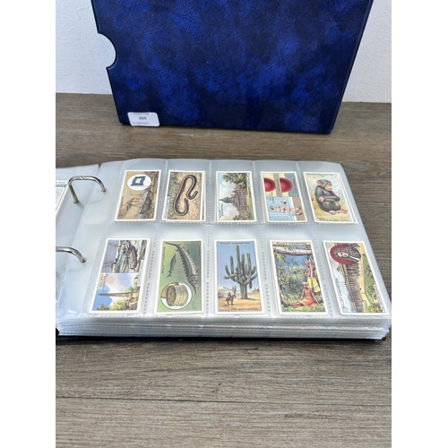 494 - A cigarette card album containing a large collection of various cigarette cards