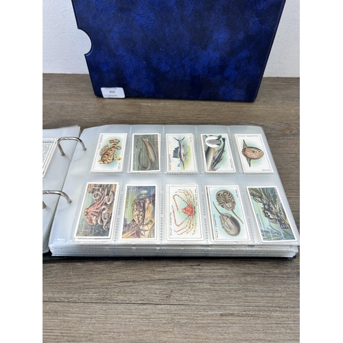 494 - A cigarette card album containing a large collection of various cigarette cards