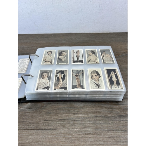 495 - A cigarette card album containing a large collection of various cigarette cards