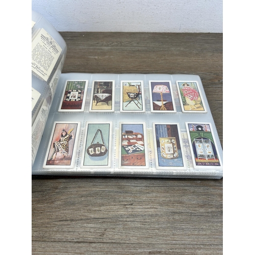 495 - A cigarette card album containing a large collection of various cigarette cards