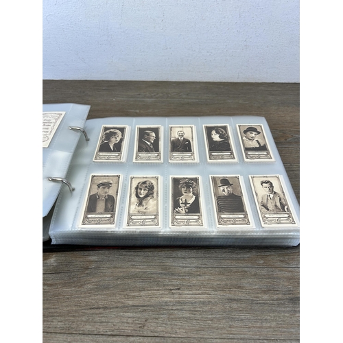 496 - A cigarette card album containing a large collection of various cigarette cards