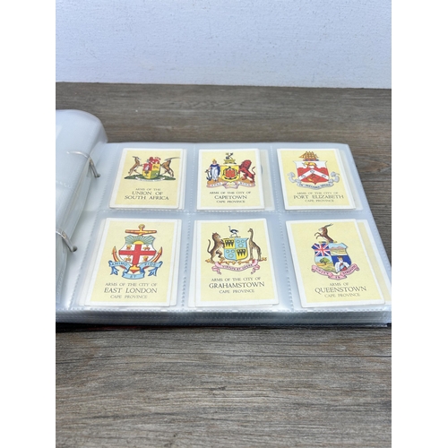 496 - A cigarette card album containing a large collection of various cigarette cards