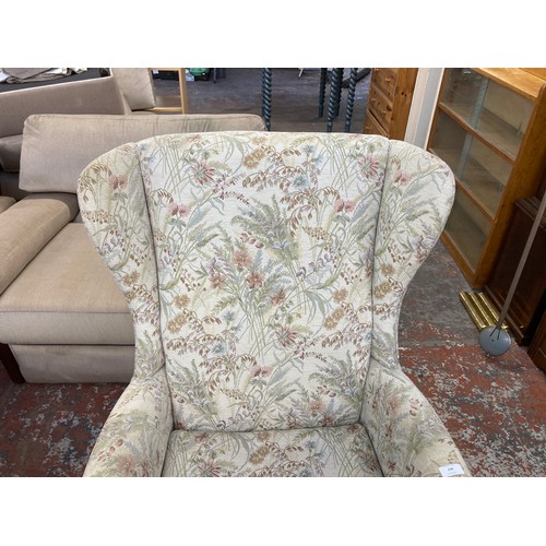 230 - A mid 20th century Parker Knoll PK750 beech and floral fabric upholstered wingback armchair