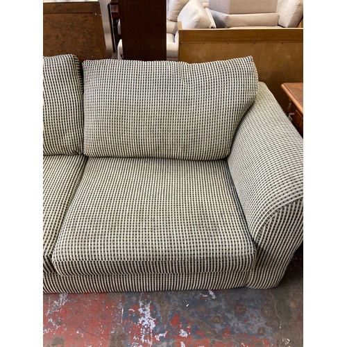 204 - A modern fabric upholstered three seater sofa