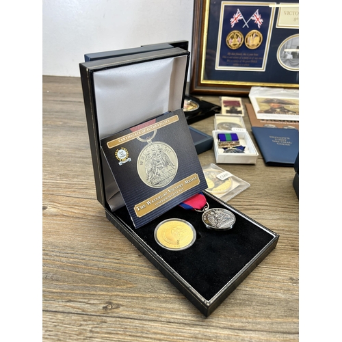 568 - A collection of coins and medals to include framed limited edition 009/299 'Victory in Europe 8th of... 