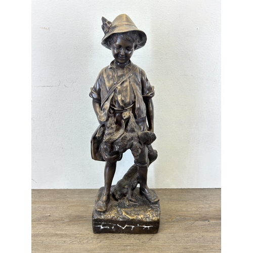 572 - An early/mid 20th century chalkware and bronzed statue of a young boy hunting game - approx. 54cm hi... 