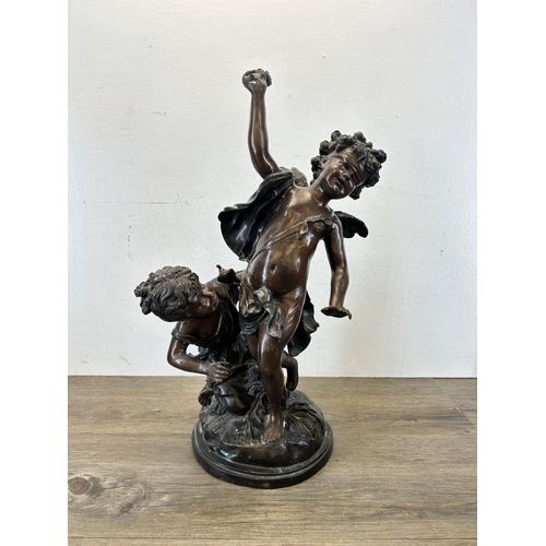 573 - A late 19th/early 20th century cast bronze blindfolded Cupid with young girl statue after Edme Bouch... 